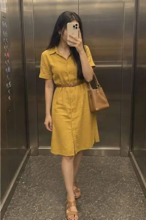Aadhya, 24, call girl in Kurla, Mumbai: mirror photo in a lift in a mustard shirt dress, her phone in front of her face