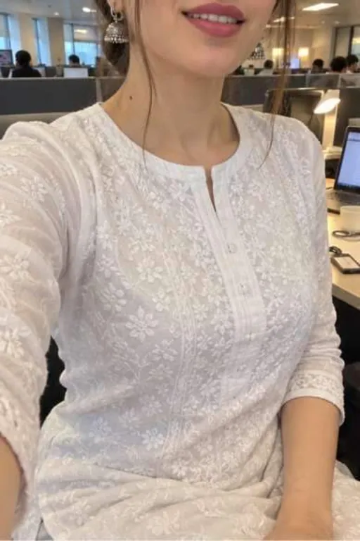Aarna, 26, call girl in Lower Parel, Mumbai: at her office desk in a white chikan kurta, the photo cut above her lips