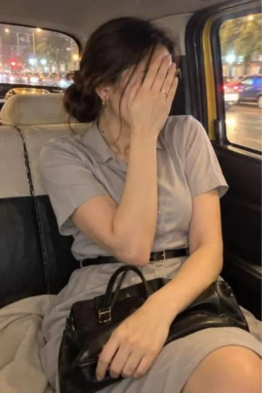 Aarna, 26, call girl in Lower Parel, Mumbai: in a taxi in a grey shirt dress, her hand over her face