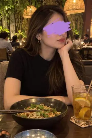 Aarna, 26, call girl in Lower Parel, Mumbai: at a restaurant in a black top with noodles, a scribble over her eyes