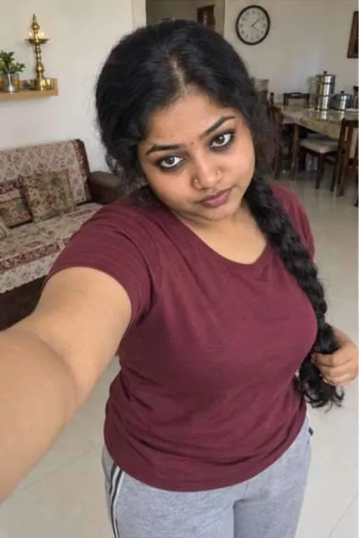 Bhavna, 26, call girl in Borivali, Mumbai: selfie at home in a maroon tee, holding her long plait