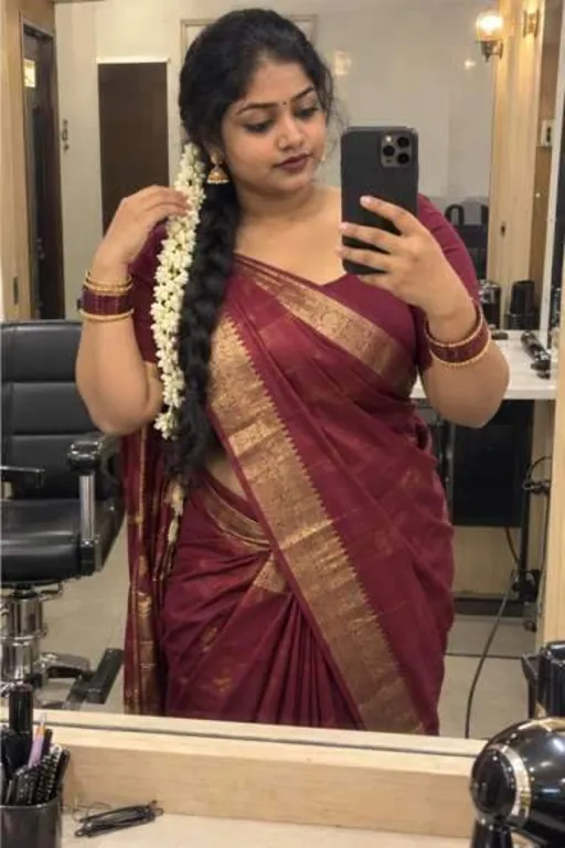 Bhavna, 26, call girl in Borivali, Mumbai: mirror photo at a salon in a maroon silk saree with jasmine in her hair