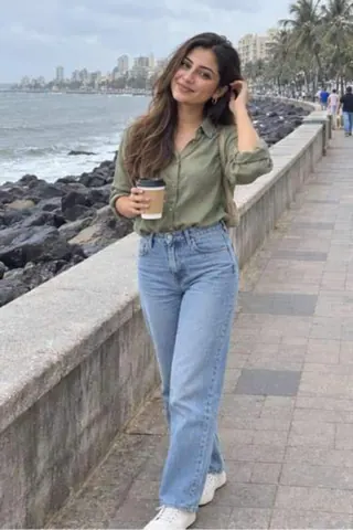 Diya, 24, call girl in Bandra, Mumbai: on the Carter Road promenade in an olive shirt and jeans with a coffee