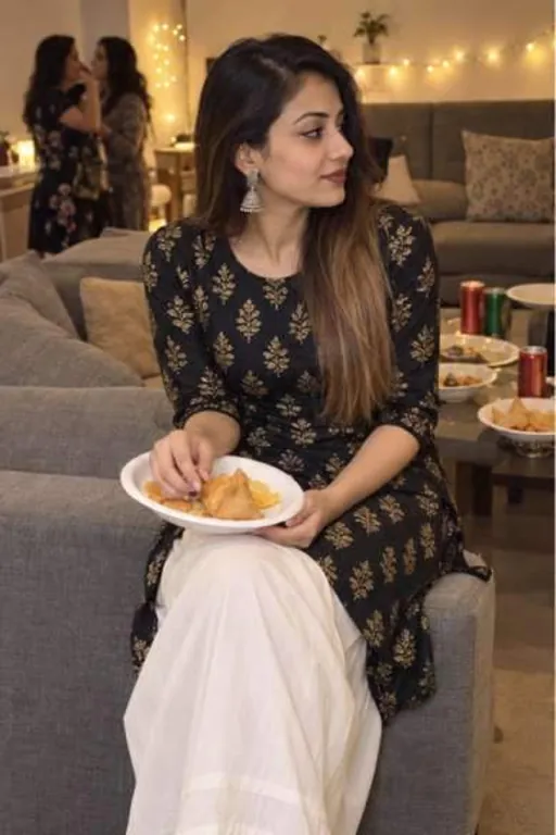 Kiyara, 23, call girl in Nerul, Mumbai: at a house party in a black kurta with a plate of snacks