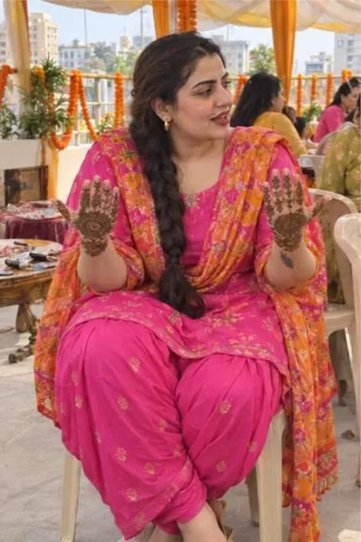 Lavleen, 28, call girl in Juhu, Mumbai: at a friend's mehendi in a pink Patiala suit, showing her henna
