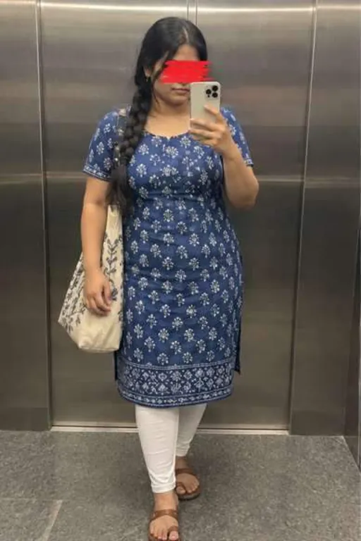 Nisha, 26, call girl in Andheri, Mumbai: mirror photo in a lift in a blue printed kurta, a red scribble over her eyes