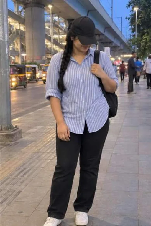 Nisha, 26, call girl in Andheri, Mumbai: under the metro line in Andheri in a striped shirt and a cap pulled low
