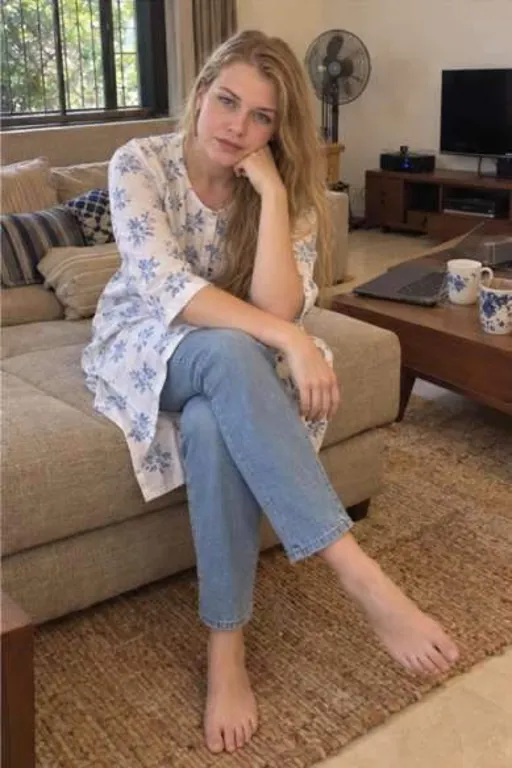 Olesya, 27, call girl in Juhu, Mumbai: on a sofa at home in a printed kurta and jeans